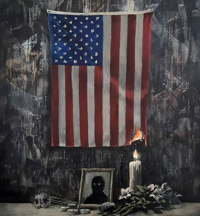 Δολοφονία Φλόιντ: Ο Banksy “βάζει φωτιά” στην αμερικάνικη σημαία και ανάβει ένα κερί