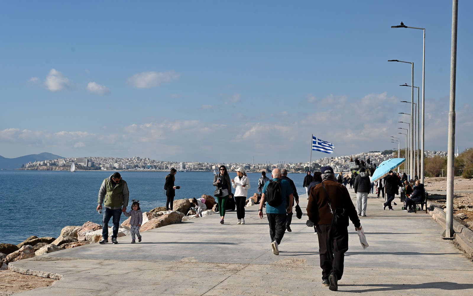 Άνθρωποι περπατούν σε παραλία της πρωτεύουσας στις 14 Ιανουαρίου