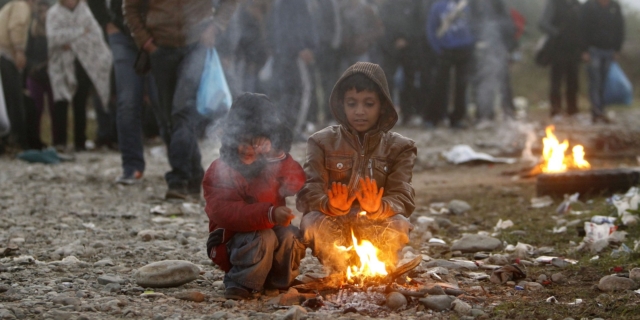 Πρόσφυγες προσπαθούν να ζεσταθούν