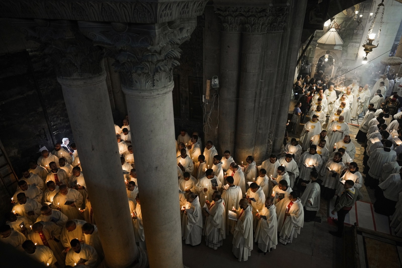 Καθολικοί κληρικοί κρατούν κεριά καθώς περπατούν κατά τη διάρκεια της πομπής του πλυσίματος των ποδιών στην εκκλησία του Παναγίου Τάφου, όπου πολλοί χριστιανοί πιστεύουν ότι ο Ιησούς σταυρώθηκε, θάφτηκε και αναστήθηκε, στην Παλιά Πόλη της Ιερουσαλήμ