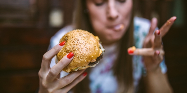 Γυναίκα τρώει burger