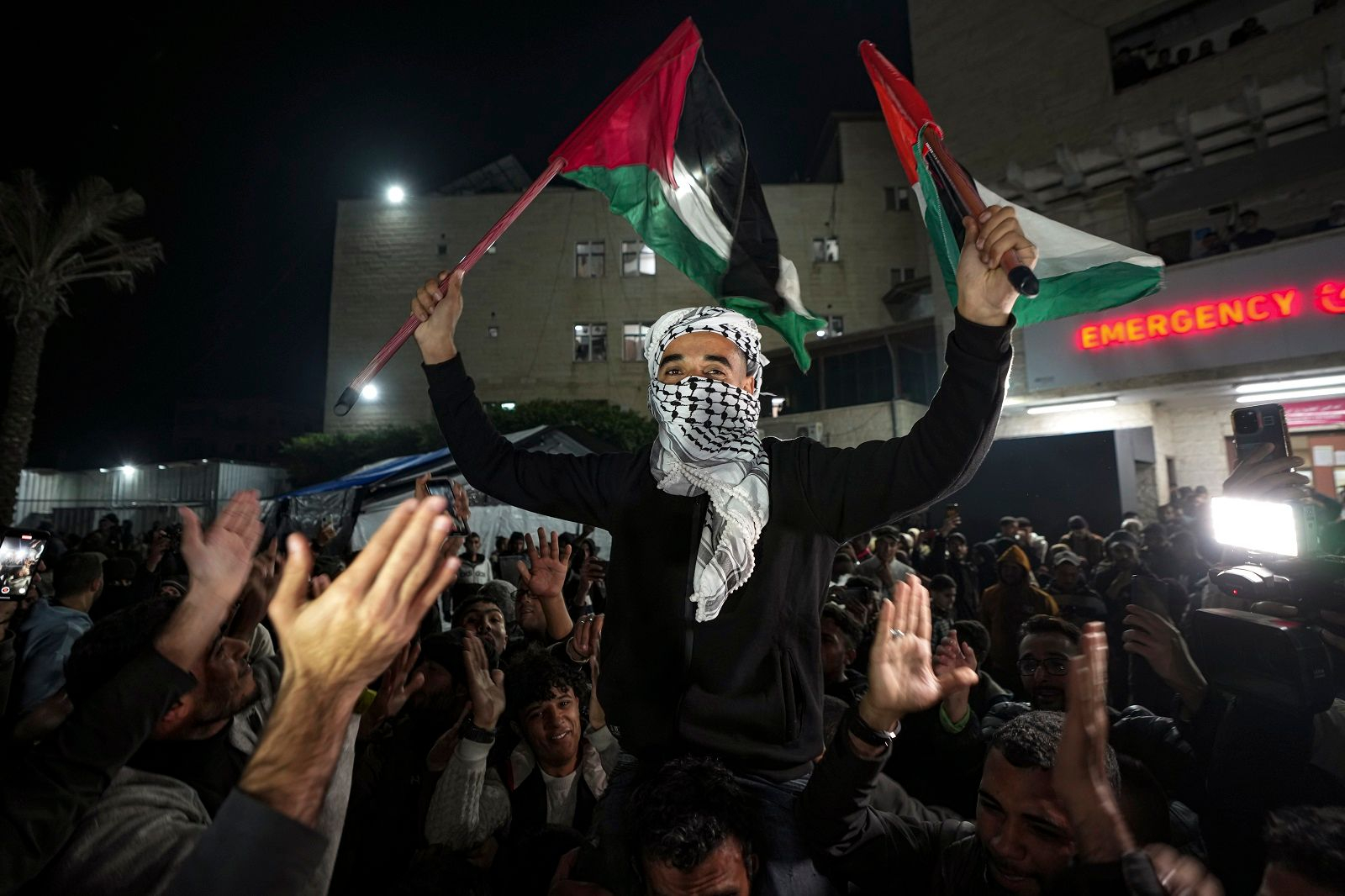 a man holding flags in the air
