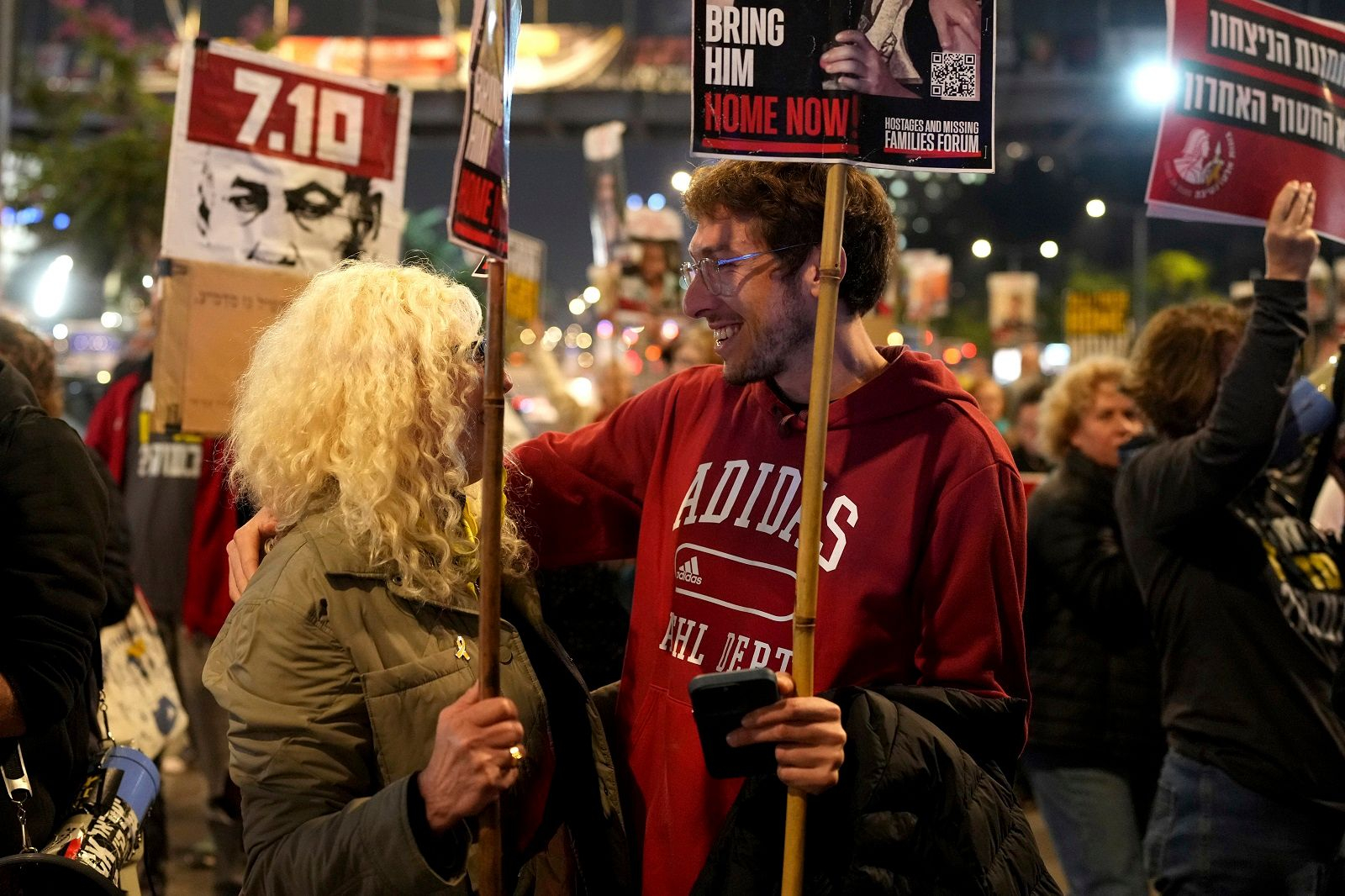 a man holding signs and smiling at another man