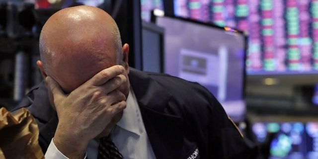 A trader has his head in his hand on the floor of the New York Stock Exchange, Thursday, March 12, 2020. The stock market had its biggest drop since the Black Monday crash of 1987 as fears of economic fallout from the coronavirus crisis deepened. The Dow industrials plunged more than 2,300 points, or 10%. The vast majority of people recover from the new coronavirus. According to the World Health Organization, most people recover in about two to six weeks, depending on the severity of the illness. ()