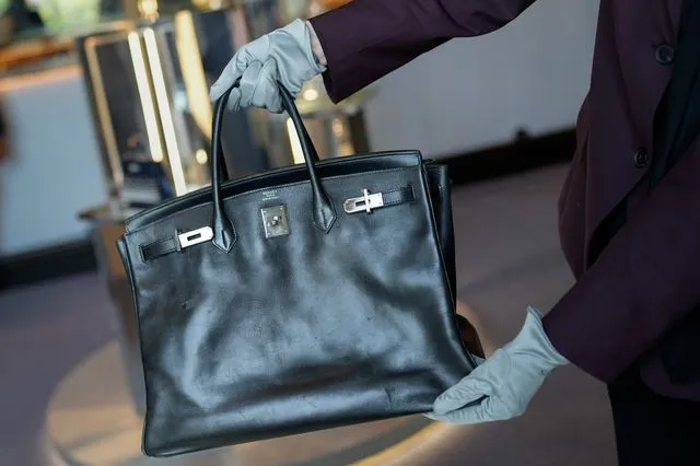 Yπάλληλος δείχνει την τσάντα Birkin που δόθηκε στην Jane Birkin από την Hermès το 2003, κατά τη διάρκεια της εβδομάδας συλλεκτών του Sotheby’s στο Άμπου Ντάμπι, Ηνωμένα Αραβικά Εμιράτα, την Τετάρτη 3 Δεκεμβρίου 2025