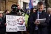 Demonstrators hold placards and flags as they attend a protest against the opening of the new Chinese embassy, in London, Saturday, Jan. 17, 2026.