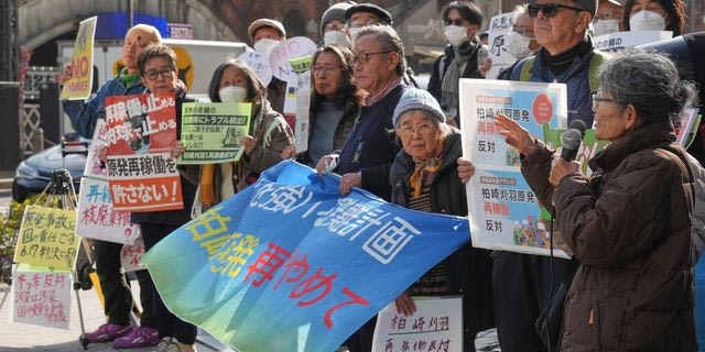 Protesters hold a sign during a rally against the restart of the No. 6 reactor at the Kashiwazaki-Kariwa nuclear power plant, in front of Tokyo Electric Power Company Holdings (TEPCO) headquarters in Tokyo Monday, Jan. 19, 2026.