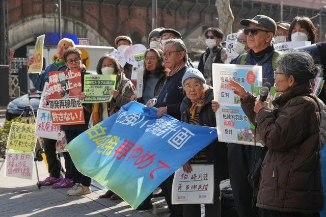 Protesters hold a sign during a rally against the restart of the No. 6 reactor at the Kashiwazaki-Kariwa nuclear power plant, in front of Tokyo Electric Power Company Holdings (TEPCO) headquarters in Tokyo Monday, Jan. 19, 2026.