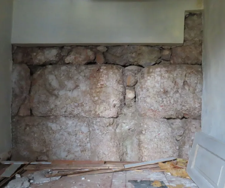 Ο αναλημματικός τοίχος στο ισόγειο του μεσαίου δωματίου της οικίας