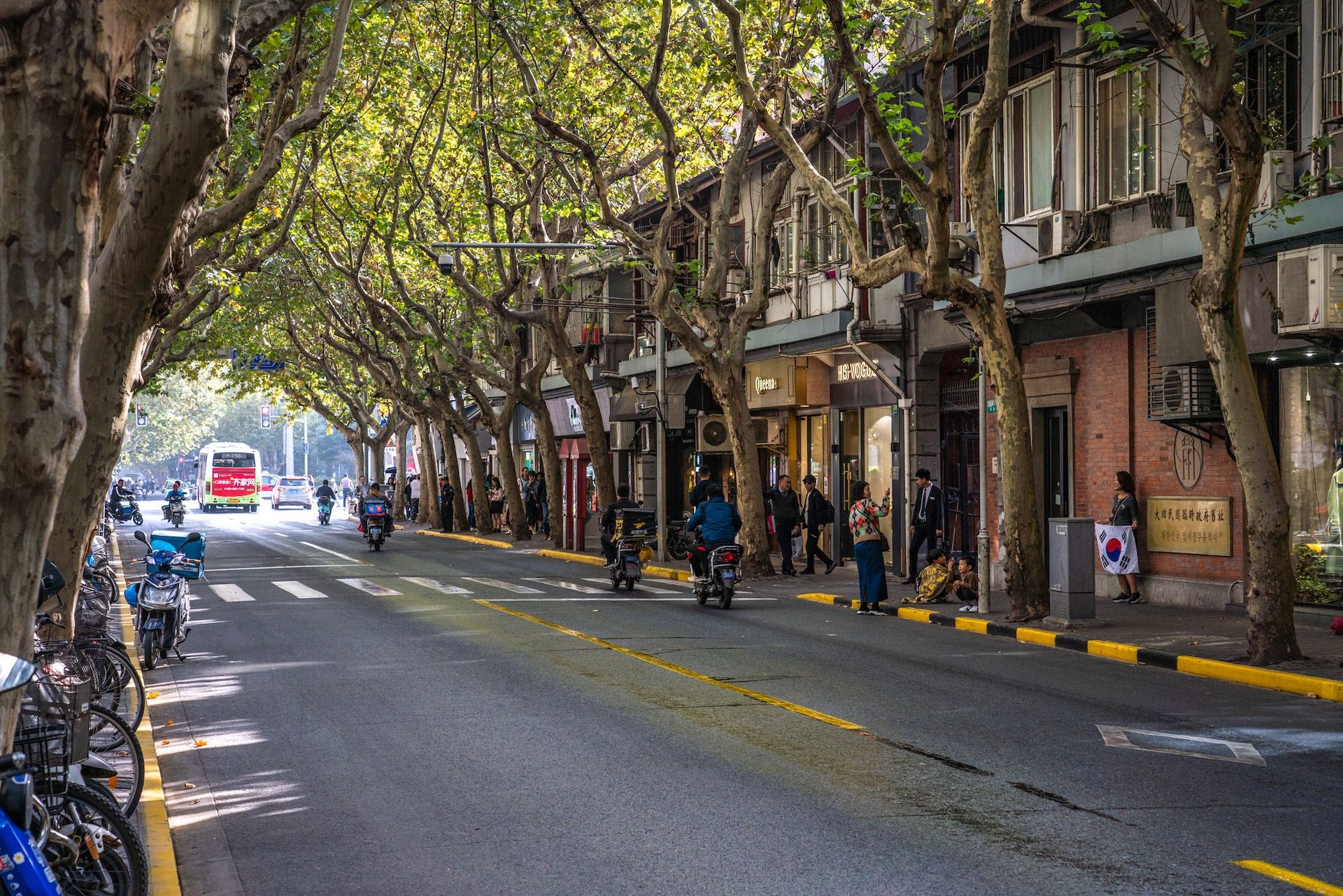 SHANGHAI, CHINA, OCTOBER 31: Tree lined luxury shopping street in the Xintiandi area of the French Concession on October 31, 2019 in Shanghai